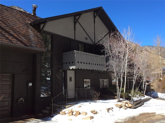 817 Valley View Dr, Georgetown, CO 80444 - view of snowy exterior with roof with shingles