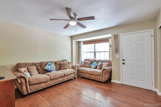 12333 Newport Ct, Brighton, CO 80602 - living room with light wood-style flooring, a ceiling fan, and baseboards