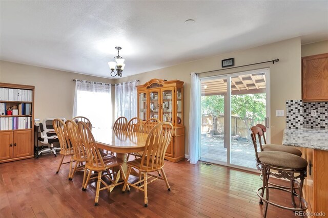 12333 Newport Ct, Brighton, CO 80602 - dining area featuring a chandelier and light wood-type flooring