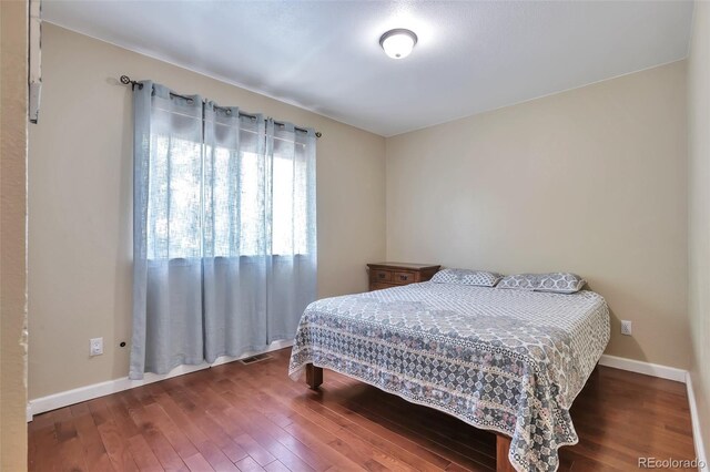 12333 Newport Ct, Brighton, CO 80602 - bedroom with hardwood / wood-style floors and baseboards