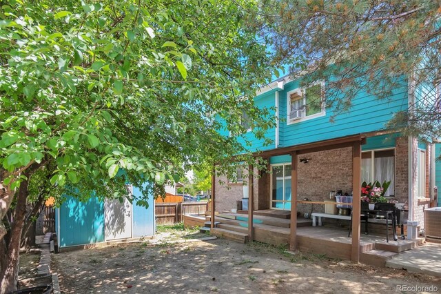 12333 Newport Ct, Brighton, CO 80602 - back of property featuring brick siding and a deck