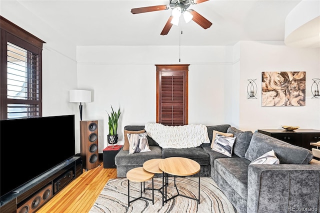 living room featuring hardwood / wood-style floors and ceiling fan