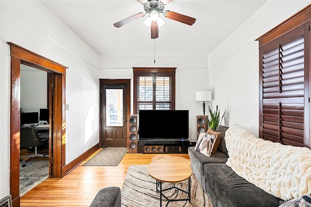 living room featuring ceiling fan and light wood-type flooring