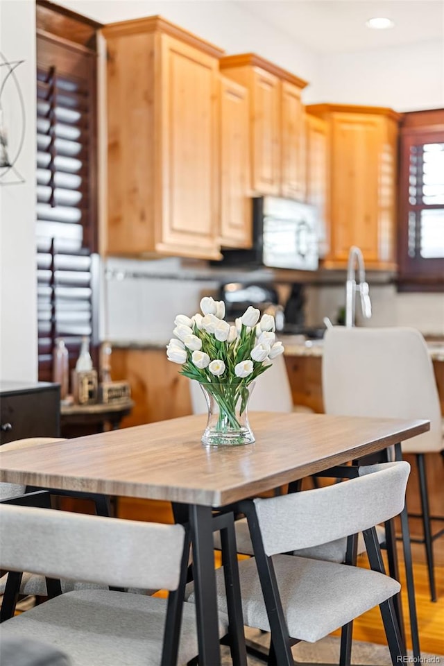 kitchen with hardwood / wood-style flooring, wooden counters, and light brown cabinetry