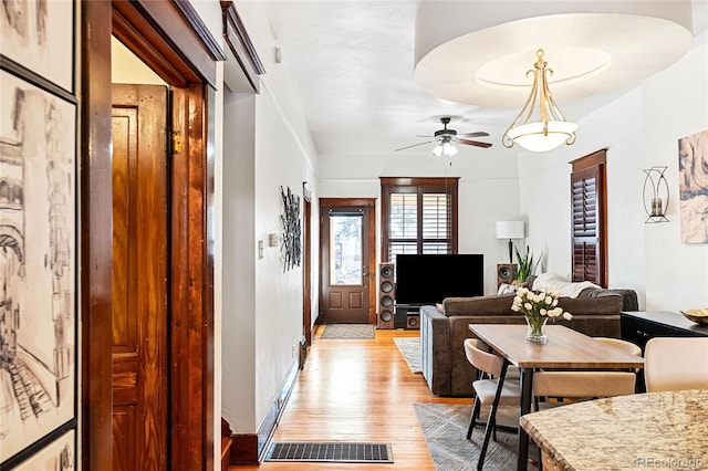 interior space with ceiling fan and light hardwood / wood-style flooring