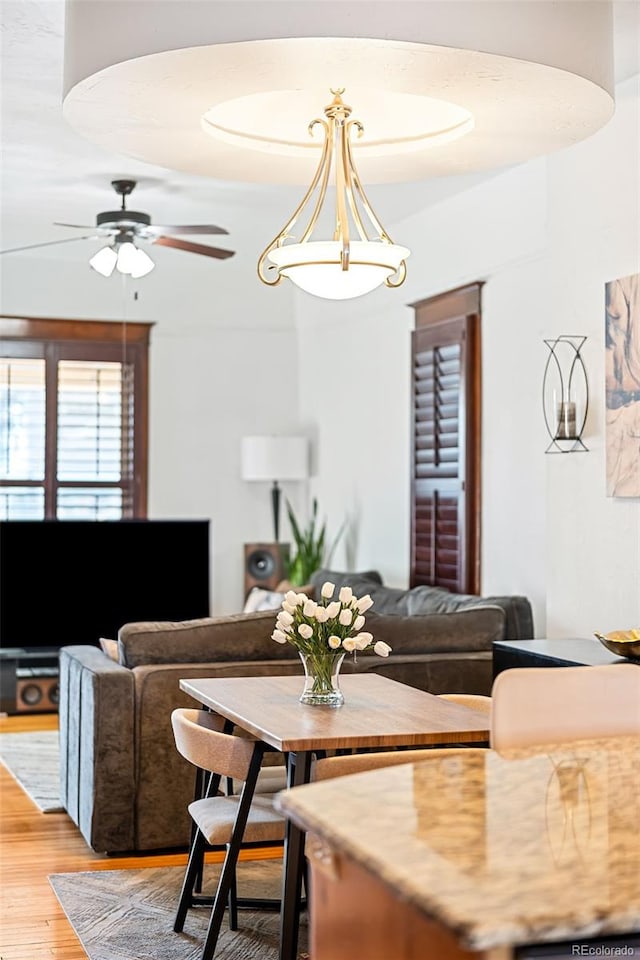 dining space featuring hardwood / wood-style floors and ceiling fan