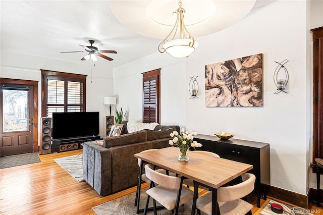 living room with light hardwood / wood-style flooring and ceiling fan