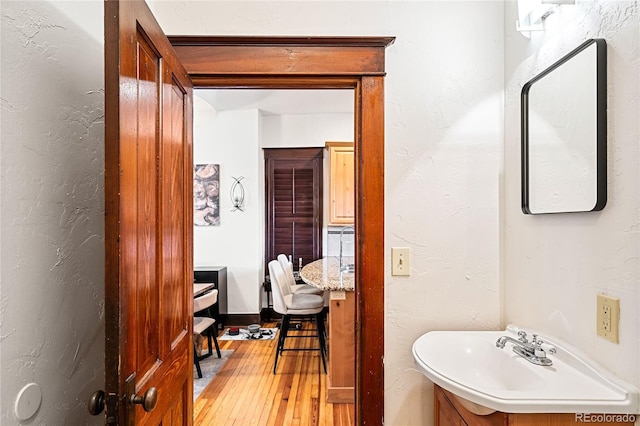 bathroom with sink and hardwood / wood-style floors