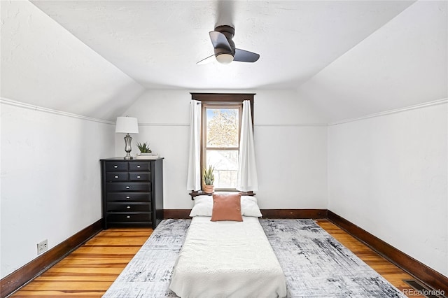 bedroom featuring vaulted ceiling, hardwood / wood-style floors, and ceiling fan