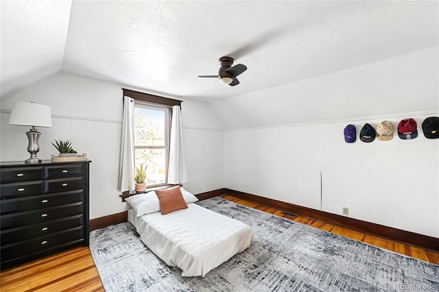 interior space featuring hardwood / wood-style flooring, lofted ceiling, and ceiling fan