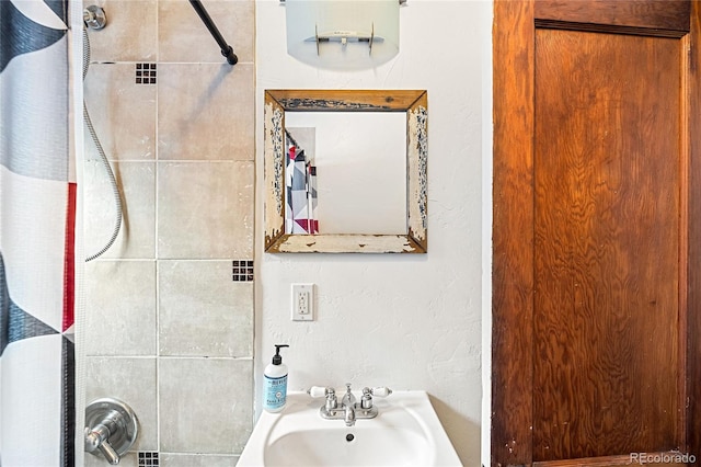 bathroom featuring sink and a shower with shower curtain