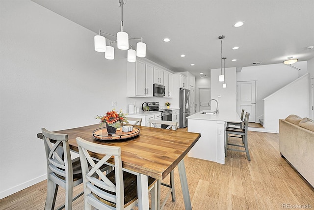 4027 E 98th Pl, Thornton, CO 80229 - dining area featuring recessed lighting, light wood finished floors, and baseboards