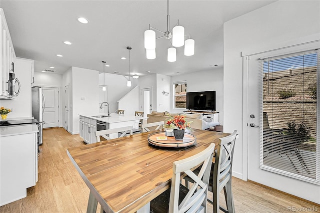 4027 E 98th Pl, Thornton, CO 80229 - dining space featuring light wood finished floors, recessed lighting, and a chandelier