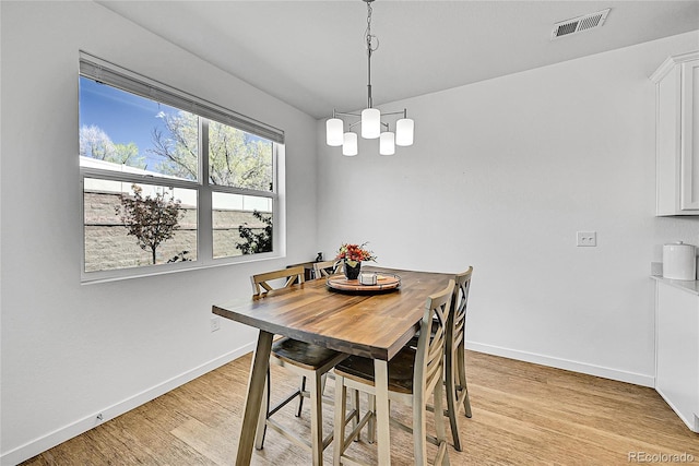 4027 E 98th Pl, Thornton, CO 80229 - dining space featuring baseboards, light wood-style flooring, and a chandelier