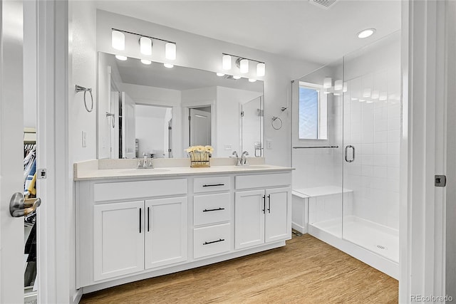 4027 E 98th Pl, Thornton, CO 80229 - full bath featuring a stall shower, double vanity, wood finished floors, and recessed lighting