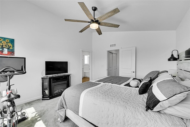 4027 E 98th Pl, Thornton, CO 80229 - bedroom with carpet flooring, baseboards, ceiling fan, a glass covered fireplace, and high vaulted ceiling