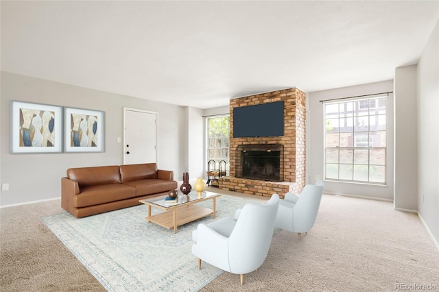 carpeted living room with a fireplace and baseboards