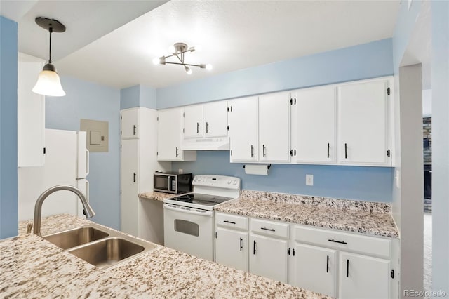kitchen featuring a sink, white appliances, decorative light fixtures, under cabinet range hood, and white cabinets