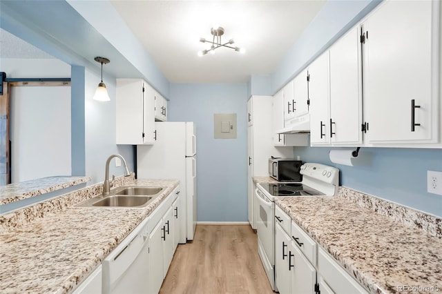 kitchen with a sink, white appliances, under cabinet range hood, light wood-style flooring, and white cabinets