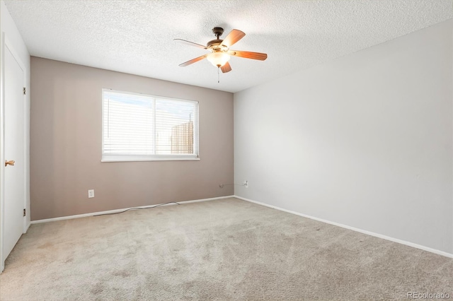 empty room featuring carpet flooring, a textured ceiling, baseboards, and a ceiling fan