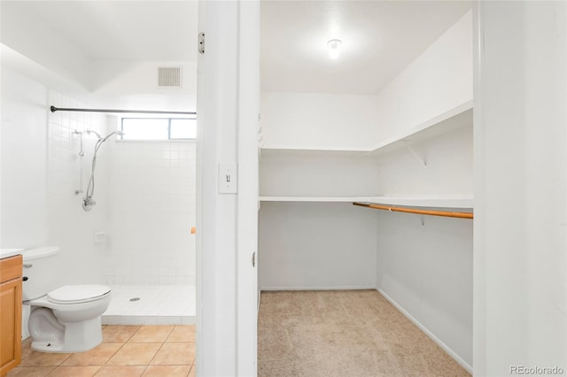 full bath with vanity, toilet, a shower stall, and visible vents