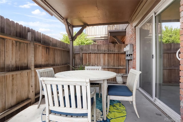 view of patio with fence and outdoor dining space