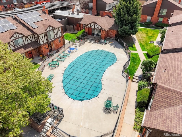 view of swimming pool featuring fence