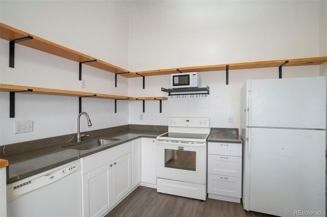 3405 W 16th St Unit 14C, Greeley, CO 80634 - kitchen with white appliances, open shelves, a sink, dark wood-style flooring, and dark countertops