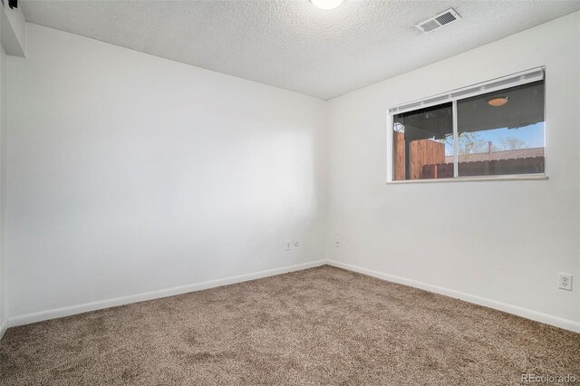 3405 W 16th St Unit 14C, Greeley, CO 80634 - unfurnished room with carpet, a textured ceiling, and baseboards