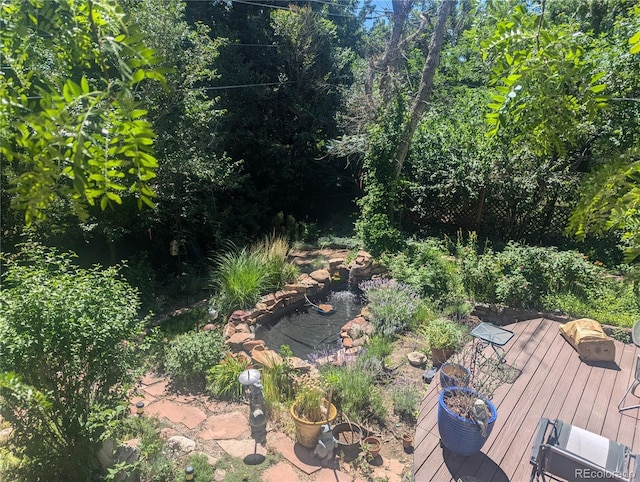 1080 Ithaca Dr, Boulder, CO 80305 - view of yard with a wooden deck and a garden pond