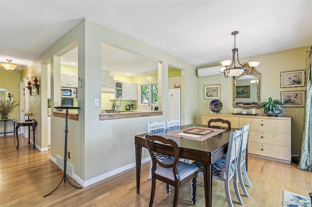 1080 Ithaca Dr, Boulder, CO 80305 - dining area featuring a chandelier, light wood finished floors, and a wall unit AC