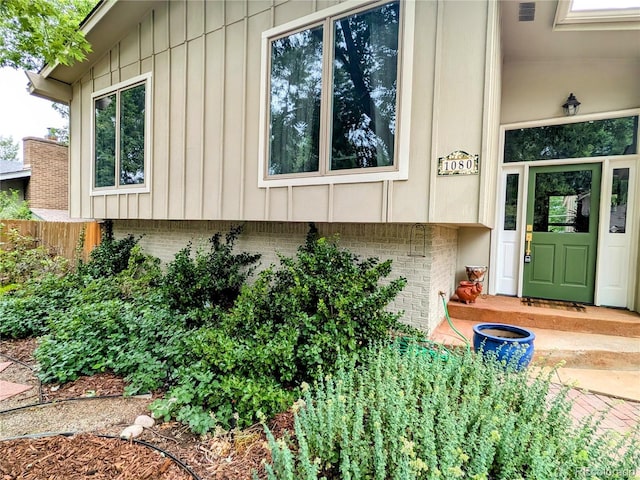 1080 Ithaca Dr, Boulder, CO 80305 - doorway to property featuring brick siding and board and batten siding