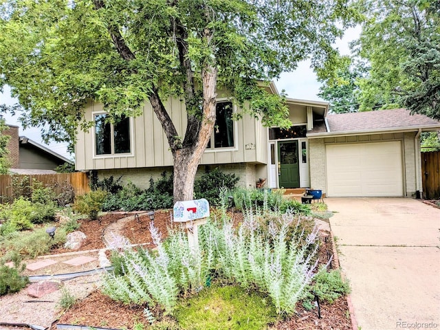 1080 Ithaca Dr, Boulder, CO 80305 - view of front of house featuring concrete driveway, brick siding, an attached garage, board and batten siding, and a shingled roof