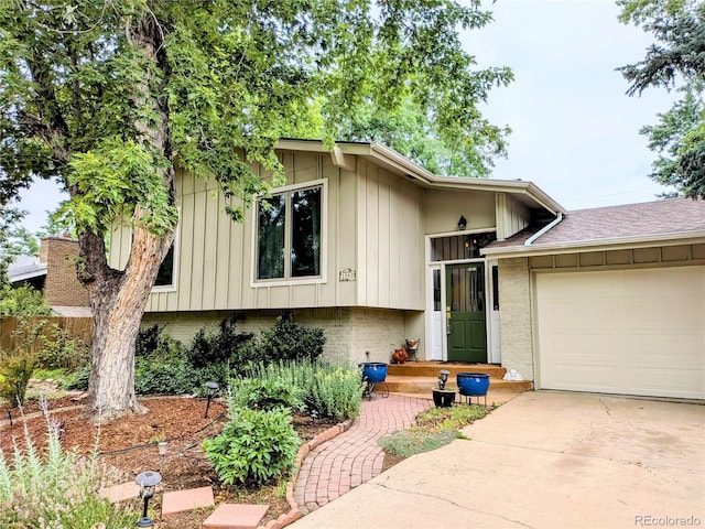 1080 Ithaca Dr, Boulder, CO 80305 - view of front facade with a garage, driveway, brick siding, and board and batten siding
