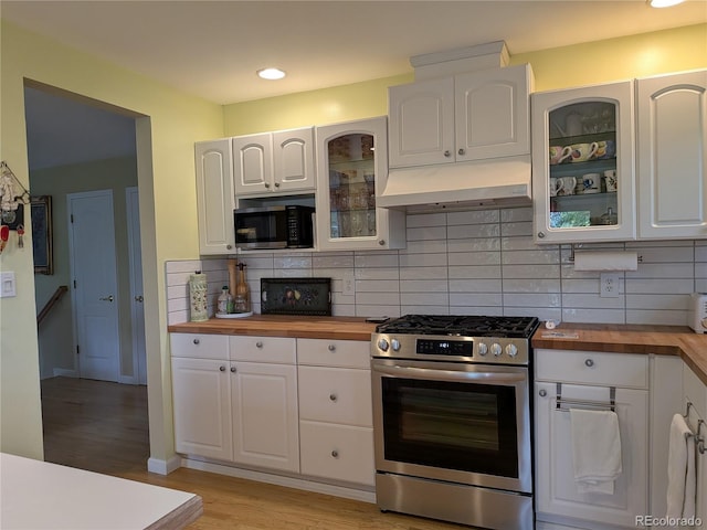 1080 Ithaca Dr, Boulder, CO 80305 - kitchen with appliances with stainless steel finishes, butcher block counters, under cabinet range hood, white cabinets, and recessed lighting