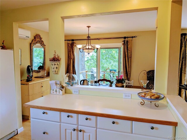 1080 Ithaca Dr, Boulder, CO 80305 - kitchen featuring freestanding refrigerator, white cabinetry, plenty of natural light, and light countertops