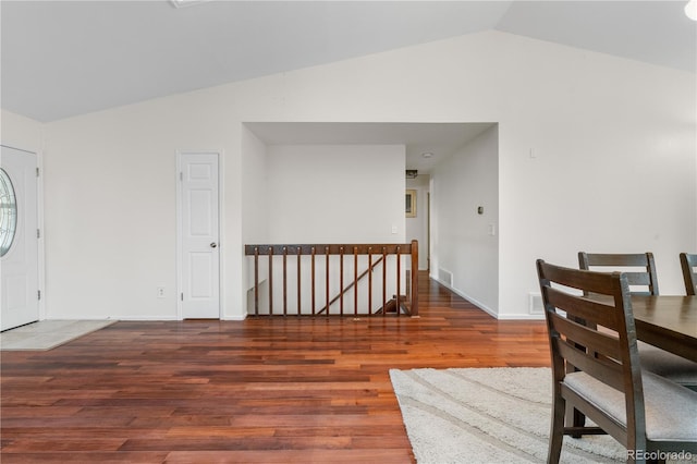 9960 Garland Ln, Broomfield, CO 80021 - dining space featuring vaulted ceiling, wood finished floors, and baseboards