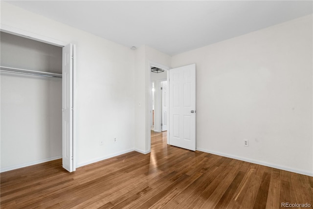 9960 Garland Ln, Broomfield, CO 80021 - unfurnished bedroom featuring wood finished floors, a closet, and baseboards