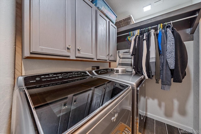 laundry room with cabinets, separate washer and dryer, and dark wood-type flooring