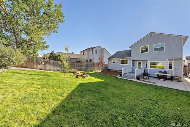 back of house with a patio and a lawn