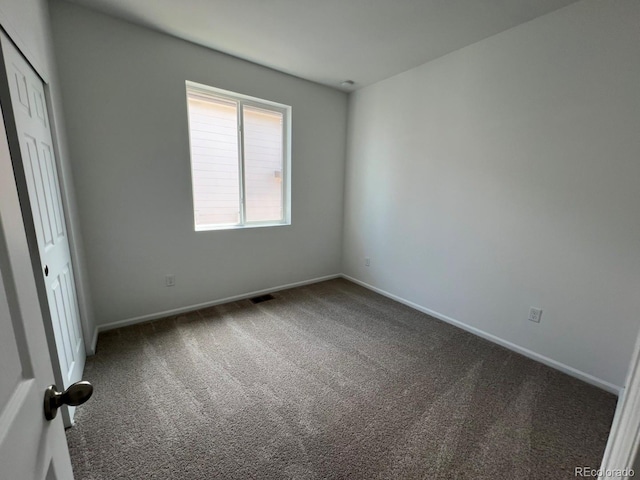 6601 N Netherland St, Aurora, CO 80019 - carpeted spare room featuring baseboards