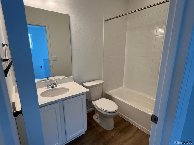 6601 N Netherland St, Aurora, CO 80019 - full bathroom with wood finished floors, vanity, washtub / shower combination, and a textured wall