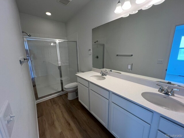 6601 N Netherland St, Aurora, CO 80019 - full bath featuring a stall shower, wood finished floors, and double vanity