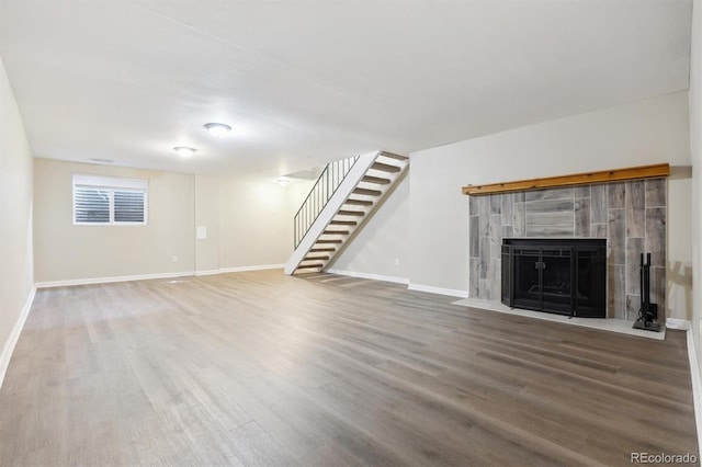 unfurnished living room with wood-type flooring and a fireplace