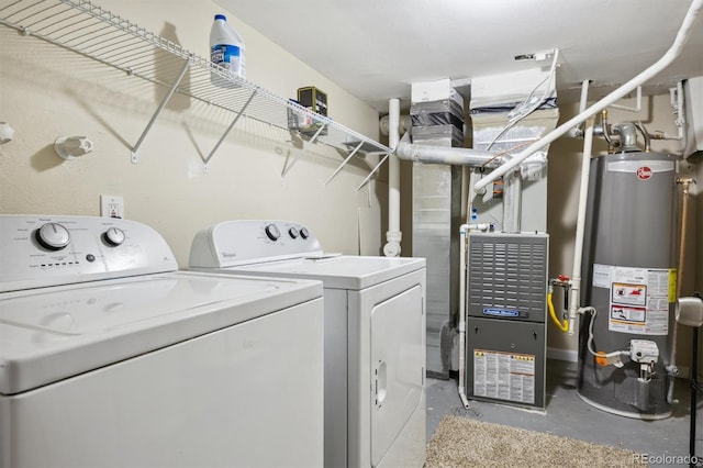 laundry area with gas water heater and washing machine and clothes dryer