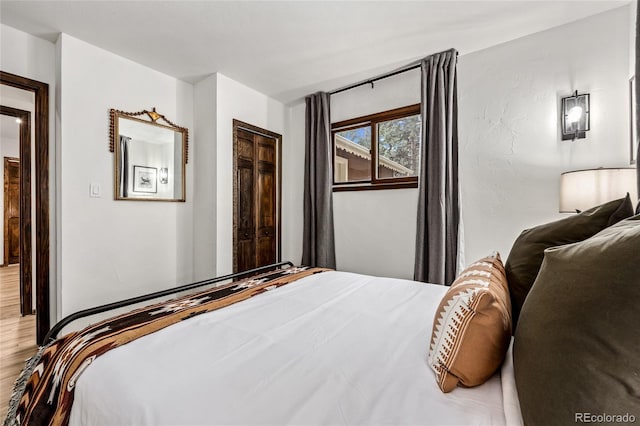 bedroom with a closet and light hardwood / wood-style floors