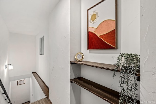 stairway with hardwood / wood-style flooring