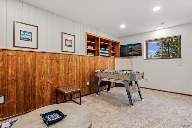 rec room with wooden walls and carpet floors