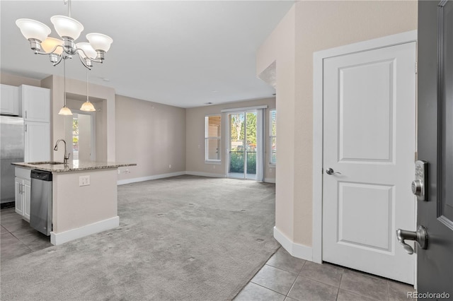 kitchen featuring light carpet, a center island with sink, decorative light fixtures, white cabinetry, and stainless steel appliances