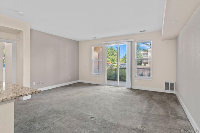 unfurnished living room featuring carpet flooring